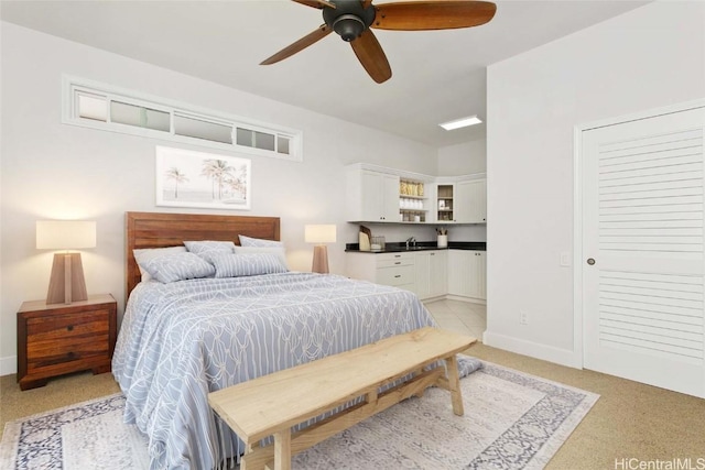 bedroom featuring sink, light colored carpet, and ceiling fan