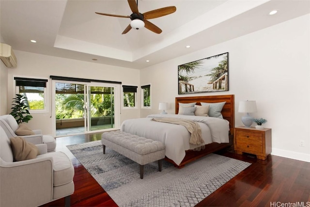 bedroom with access to exterior, dark hardwood / wood-style floors, a raised ceiling, and ceiling fan