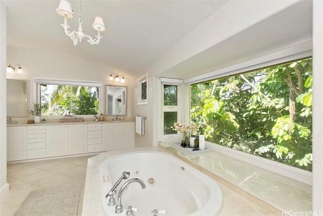 bathroom featuring lofted ceiling, tiled bath, vanity, tile patterned floors, and an inviting chandelier