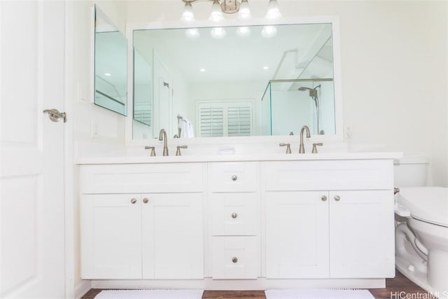 bathroom featuring vanity, hardwood / wood-style flooring, and toilet