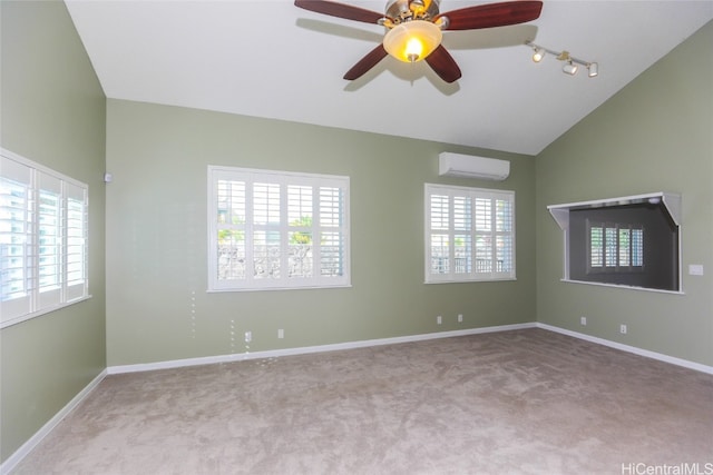 carpeted empty room featuring a wall mounted air conditioner, rail lighting, ceiling fan, and lofted ceiling