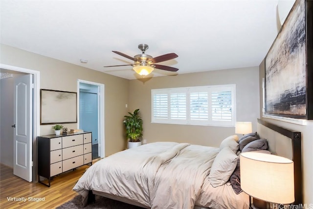 bedroom with ceiling fan and light wood-type flooring