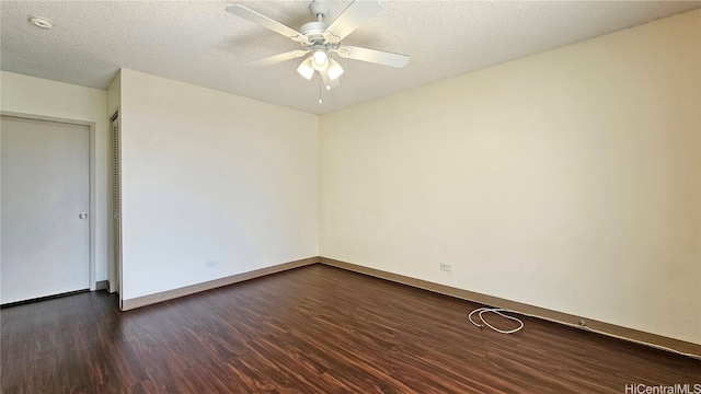 empty room featuring ceiling fan, dark hardwood / wood-style floors, and a textured ceiling