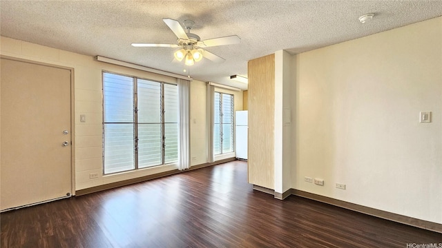 1655 Liholiho St, Honolulu, HI 96822 - empty room with dark wood-style floors, a textured ceiling, a smoke detector, a ceiling fan, and baseboards