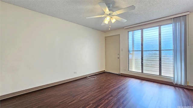 1655 Liholiho St, Honolulu, HI 96822 - empty room with dark wood-style floors, a textured ceiling, baseboards, and ceiling fan