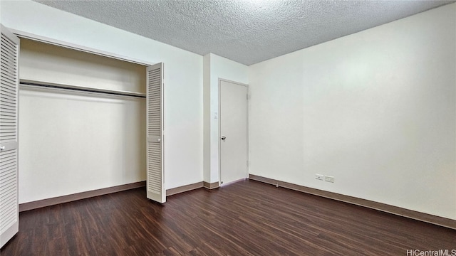 unfurnished bedroom featuring dark wood-type flooring, a closet, and a textured ceiling