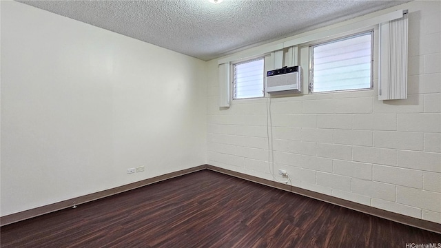 1655 Liholiho St, Honolulu, HI 96822 - spare room featuring baseboards, dark wood-style flooring, a textured ceiling, and cooling unit