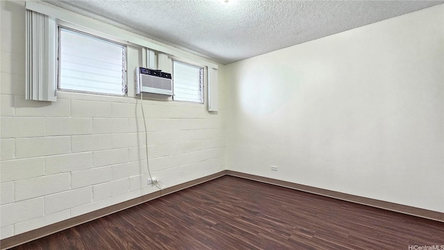 1655 Liholiho St, Honolulu, HI 96822 - unfurnished room with dark wood-style floors, baseboards, a textured ceiling, and cooling unit
