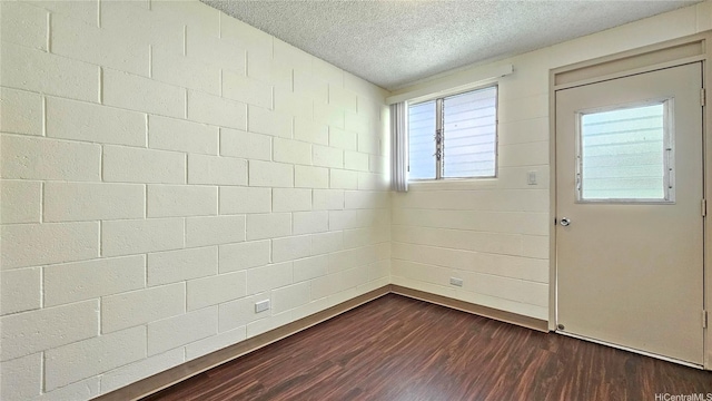 1655 Liholiho St, Honolulu, HI 96822 - entrance foyer with dark wood-style flooring, baseboards, and a textured ceiling