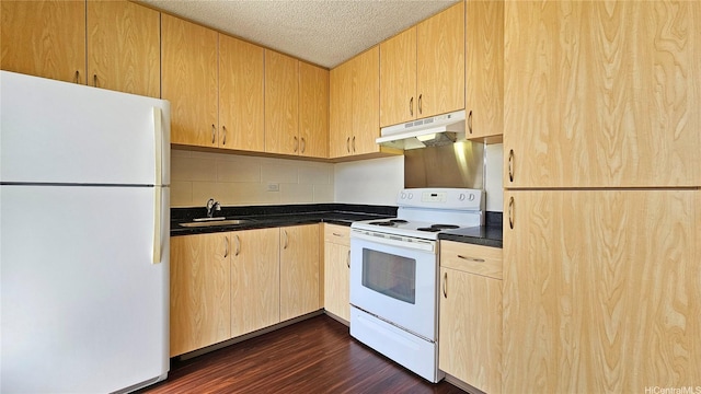 1655 Liholiho St, Honolulu, HI 96822 - kitchen featuring white appliances, under cabinet range hood, dark countertops, a sink, and light brown cabinets