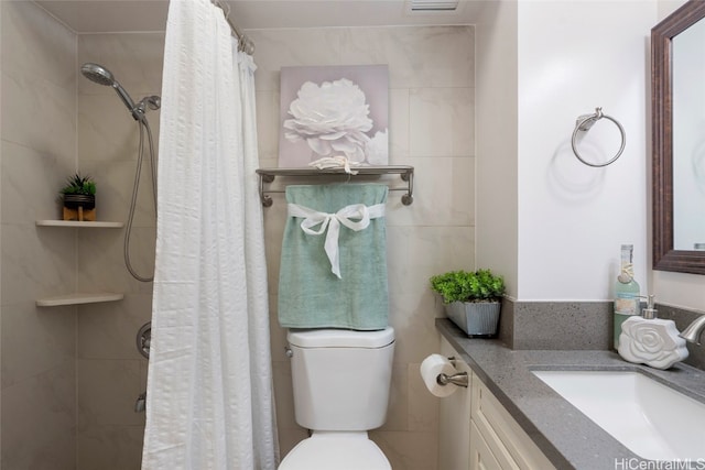 bathroom with toilet, vanity, curtained shower, and tile walls