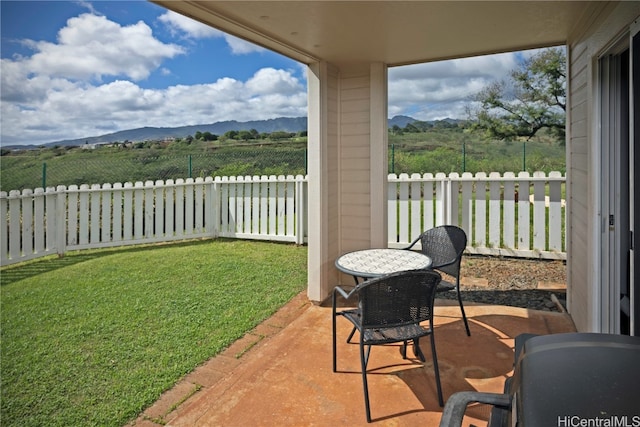 view of patio / terrace with a mountain view and a rural view