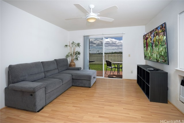 living room featuring ceiling fan and light hardwood / wood-style flooring