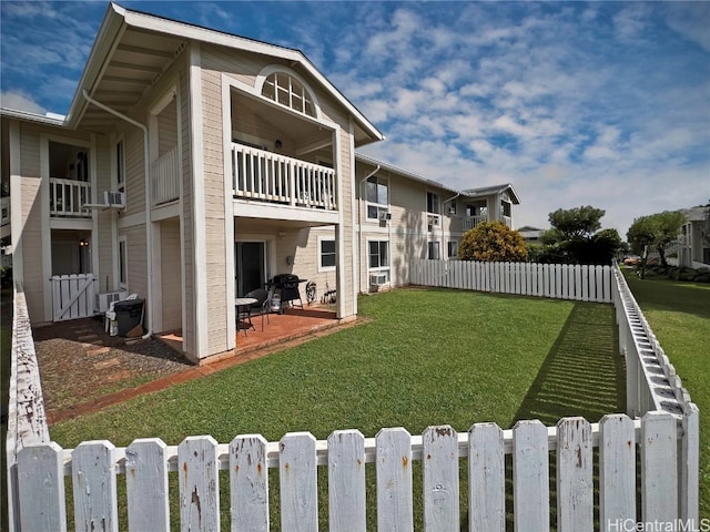 exterior space with a patio, a yard, and a balcony