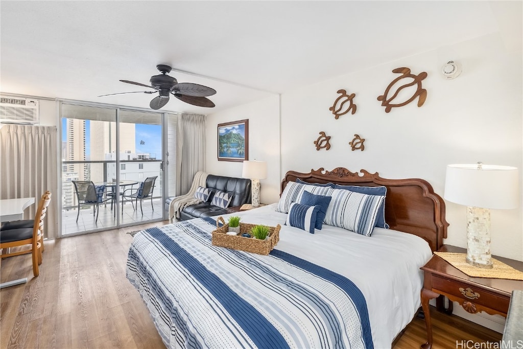 bedroom with expansive windows, access to outside, hardwood / wood-style flooring, and ceiling fan