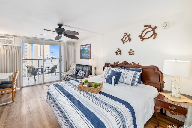 bedroom with expansive windows, access to outside, hardwood / wood-style flooring, and ceiling fan