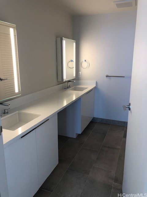 bathroom with tile patterned flooring and vanity