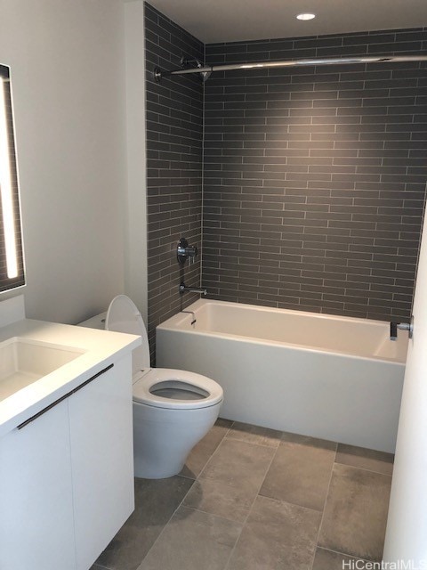 full bathroom with toilet, tiled shower / bath combo, and vanity