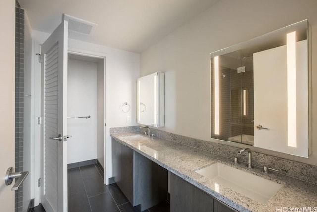 bathroom featuring an enclosed shower, vanity, and tile patterned flooring