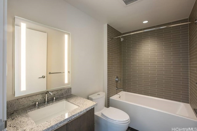 full bathroom with vanity, toilet, and tiled shower / bath combo