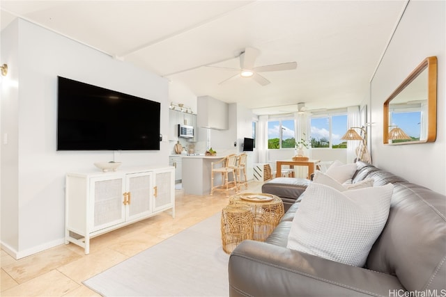 tiled living room with ceiling fan