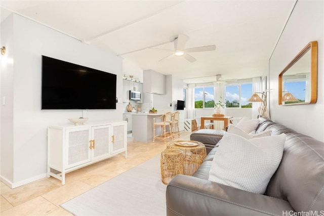 living room with ceiling fan and light tile patterned floors