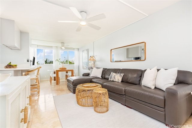 tiled living room with ceiling fan