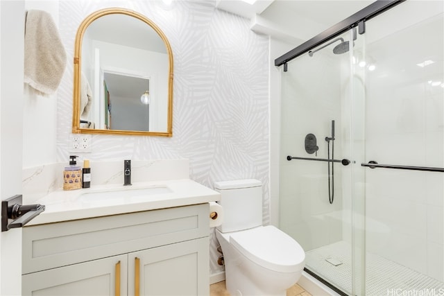 bathroom featuring vanity, toilet, and walk in shower