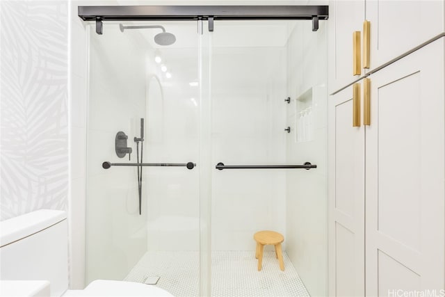 bathroom featuring toilet and walk in shower