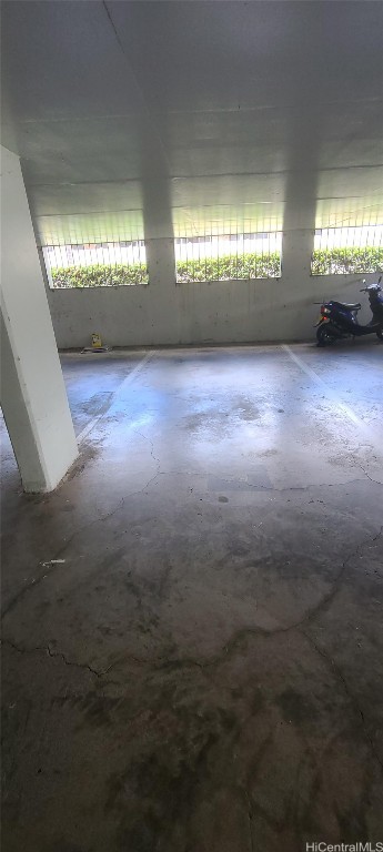 spare room with plenty of natural light and concrete flooring