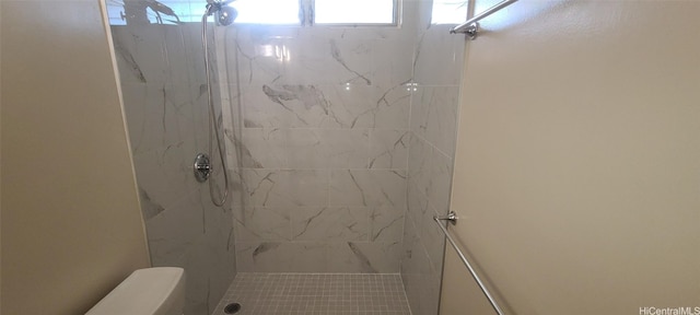 bathroom with tiled shower