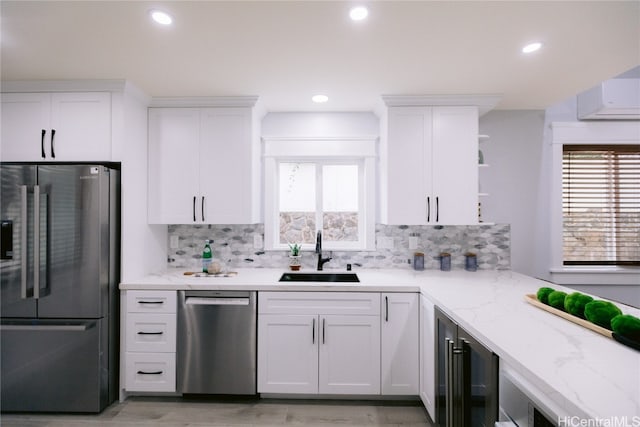 kitchen featuring white cabinets, a wealth of natural light, sink, and stainless steel appliances