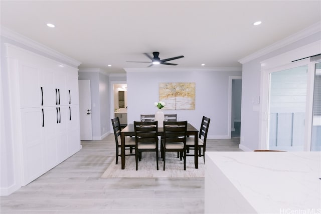 dining room featuring ceiling fan, light wood-type flooring, and ornamental molding