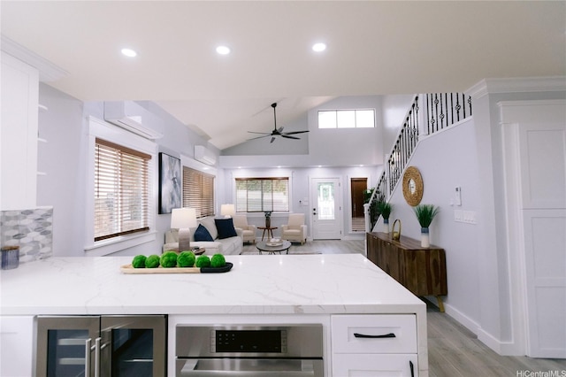 92-1310 Palahia St, Kapolei, HI 96707 - kitchen featuring wine cooler, ceiling fan, light wood-type flooring, a peninsula, and white cabinets