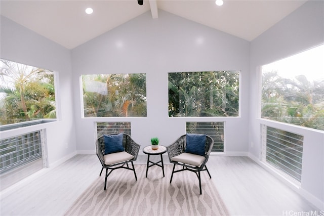 sunroom / solarium featuring lofted ceiling with beams