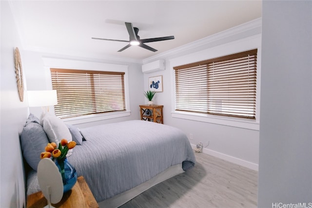 bedroom featuring light hardwood / wood-style floors, ceiling fan, an AC wall unit, and crown molding