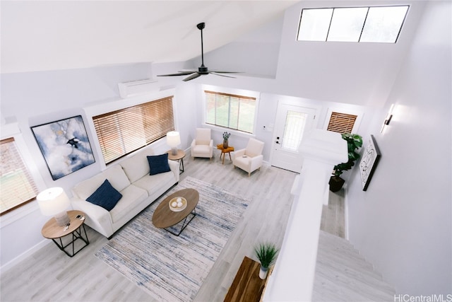 living room featuring high vaulted ceiling, light hardwood / wood-style floors, and ceiling fan