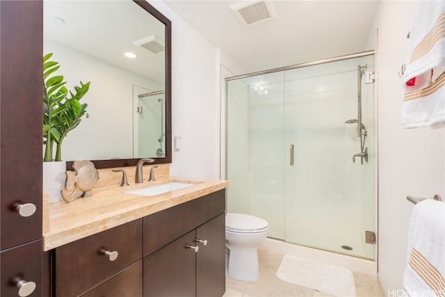 bathroom with vanity, tile patterned floors, toilet, and an enclosed shower