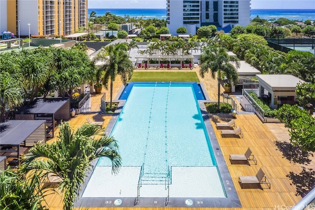 view of swimming pool featuring a water view and a patio area