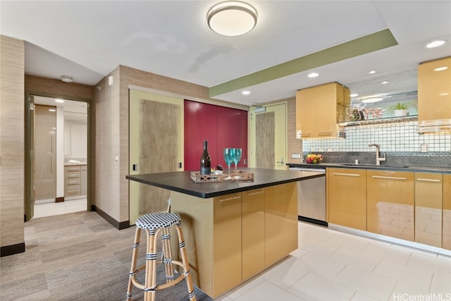 kitchen featuring a center island, dishwasher, sink, a breakfast bar, and backsplash