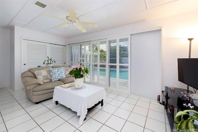 living room with light tile patterned floors and ceiling fan