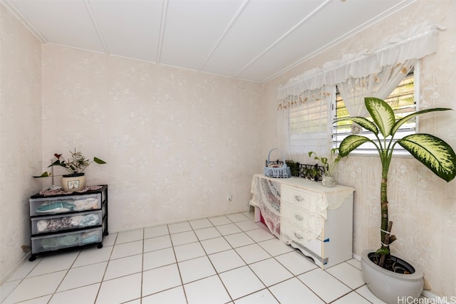 interior space with crown molding and tile patterned flooring