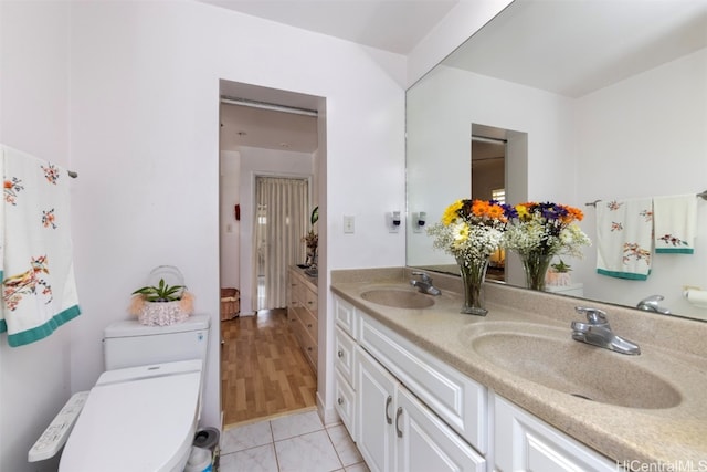 bathroom with tile patterned floors, vanity, and toilet