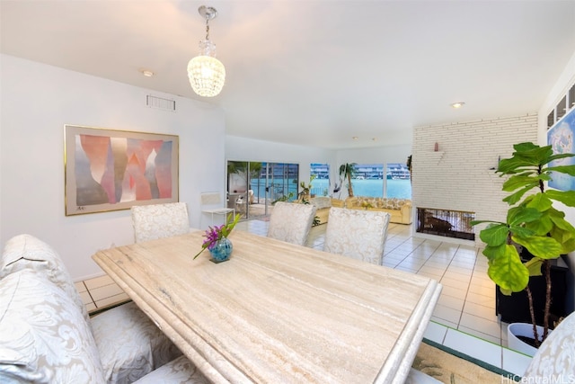 tiled dining space with a water view