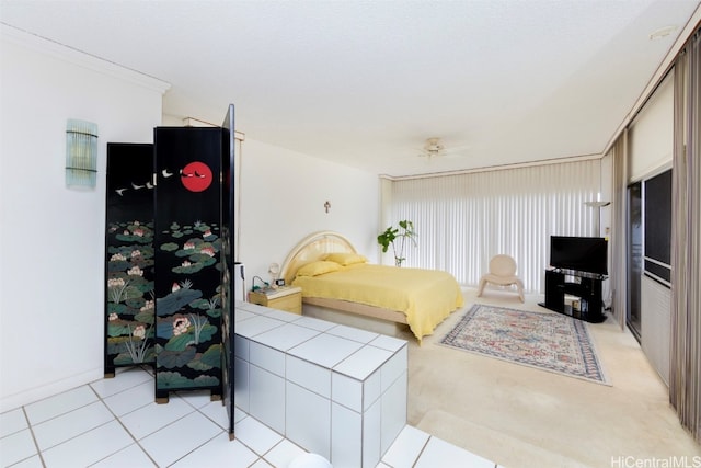 bedroom featuring light colored carpet and ornamental molding