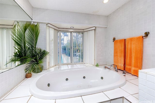 bathroom featuring a relaxing tiled tub and tile walls