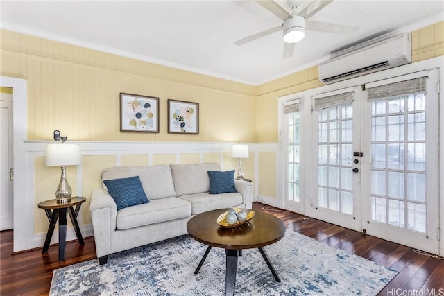 living room with ceiling fan, french doors, a wall mounted air conditioner, dark hardwood / wood-style floors, and ornamental molding