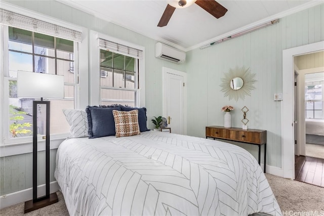 bedroom with a wall mounted air conditioner, carpet flooring, ceiling fan, and crown molding