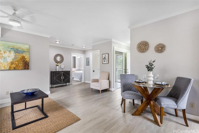 dining space featuring ceiling fan, crown molding, and light hardwood / wood-style flooring