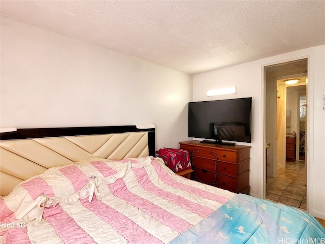 tiled bedroom with a textured ceiling